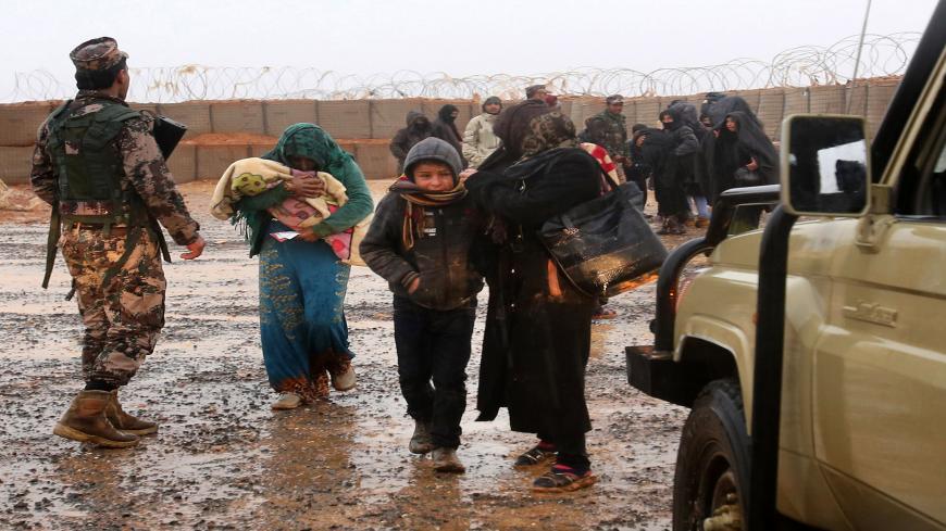 Syrian refugee patients from the makeshift Rukban camp, which lies in no-man's-land off the border between Syria and Jordan in the remote northeast, cross over to visit a UN-operated medical clinic immediately on the Jordanian-side for checkups, on March 1, 2017.
Conditions in the Rukban camp deteriorated sharply after Jordan sealed its border almost a year prior, following a cross-border jihadist attack that killed seven Jordanian border guards in June 2016. / AFP PHOTO / KHALIL MAZRAAWI (Photo cred