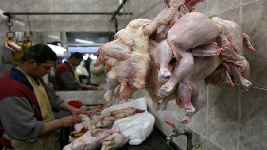 A Palestinian vendor cleans chicken at his shop in the West Bank city of Ramallah, 06 January 2008. Palestenian Health Minister Fathi Mughli said today Palestinians should be vigilant after a case of H5N1 strain of bird flu that is dangerous to humans was detected in the northern Israeli town of Binyamina on the Mediterranean coast. AFP PHOTO/ABBAS MOMANI (Photo credit should read ABBAS MOMANI/AFP via Getty Images)