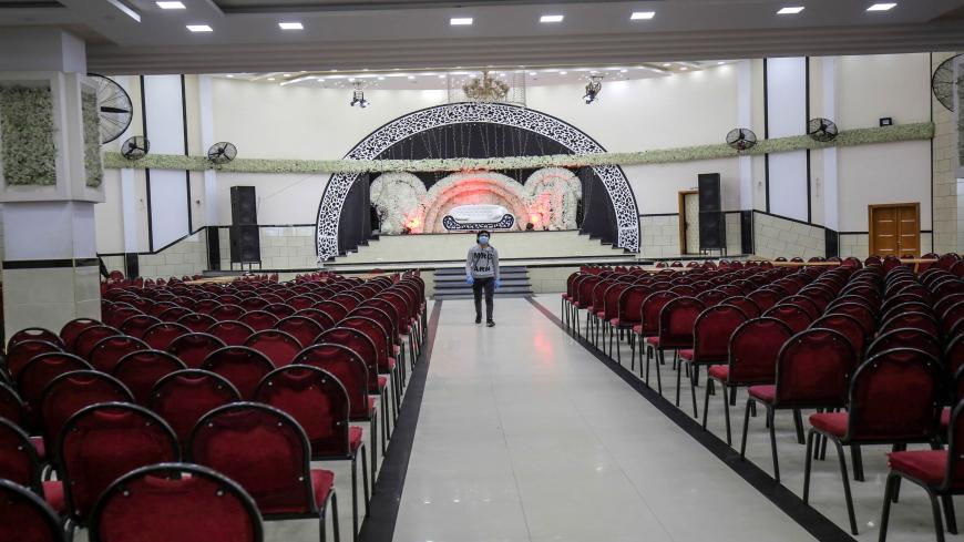A Palestinian man wearing a protective face mask as a preventive measure against the nivid coronavirus, walks inside a closed wedding venue in Rafah, in the southern Gaza Strip, on March 22, 2020. - Authorities in Gaza today confirmed the first two cases of novel coronavirus, identifying them as Palestinians who had travelled to Pakistan and were being held in quarantine since their return.
The United Nations has warned that a COVID-19 outbreak in Gaza could be disastrous, given the high poverty rates and