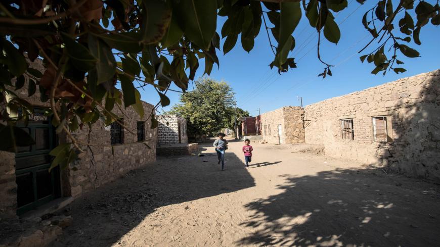Nubian girls play outside their home in the village of Abu Simbel in Egypt's far south, over 1100 kilometres south of the capital Cairo and near the border with Sudan, on February 4, 2020. - The Nubian language, according to locals, is unpractised by many in the generation born decades after their mass eviction from their ancestral lands to make way for the construction of the Aswan High Dam on the Nile in the 1960s. Built under Egypt's late president Gamal Abdel Nasser, the colossal project aimed to harnes