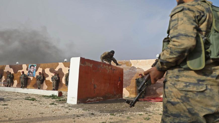 Turkey-backed Syrian rebels take part in a military exercise in Ghandoura, in the northeastern countryside of Syria's Aleppo province, on January 14, 2021. (Photo by AAREF WATAD / AFP) (Photo by AAREF WATAD/AFP via Getty Images)