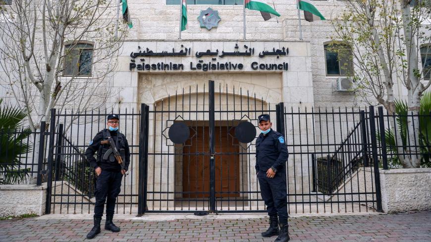 Members of the Palestinian security forces stand guard outside the  Legislative Council building in the occupied-West Bank town of Ramallah, on January 16, 202. - Palestinian president Mahmud Abbas announced yesterday dates for the first Palestinian elections in more than 15 years, setting legislative polls for May 22 and a July 31 presidential vote. 
Abbas's Fatah party, which controls the Palestinian Authority based in the occupied West Bank, and the Hamas Islamists, who hold power in Gaza, have for years