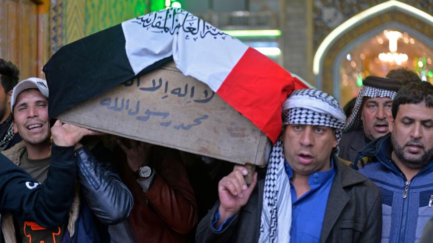Iraqi mourners carry the coffin of a victim who was killed in a twin suicide bombing in central Baghdad, during a funeral in the holy city of Najaf on January 21, 2021. - A rare twin suicide bombing killed 32 people and wounded 110 at a crowded market in central Baghdad, Iraq's government said, the city's deadliest attack in three years.
The first attacker drew a crowd at the bustling market in the capital's Tayaran Square by claiming to feel sick, then detonated his explosives belt, the interior ministry s