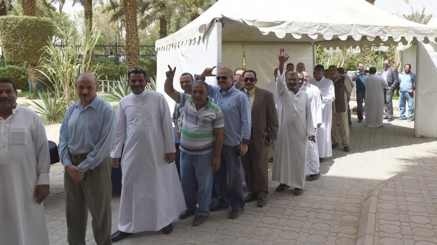 Egyptian men living in Saudi Arabia queue to casts their ballots in the early voting for the presidential elections on May 26-27, at the Egyptian embassy in Riyadh, on May 15, 2014. Egyptians abroad started voting in their country's first presidential elections since the military deposed Islamist president Mohamed Morsi nearly a year ago. Around 680,000 Egyptians, in 124 countries have registered to vote and have until May 18, to cast their ballots at diplomatic missions in their countries of residence, sta