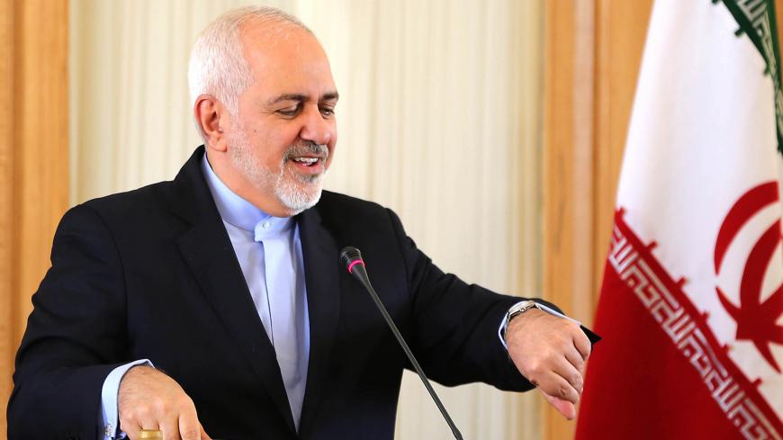 This picture taken on February 13, 2019 shows Iran's Foreign Minister Mohammad Javad Zarif checks his watch during a press conference in Tehran. - Zarif, who was the lead negotiator in the 2015 nuclear deal, announced his resignation on Instagram on February 25, 2019. "I apologise for my inability to continue serving and for all the shortcomings during my term in office," Zarif said in message posted on his verified Instagram account. (Photo by ATTA KENARE / AFP)        (Photo credit should read ATTA KENARE
