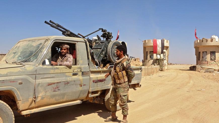 A fighter sits in a "technical" (pickup truck mounted with turret) as forces loyal to Yemen's Saudi-backed government clash with Huthi rebel fighters around the strategic government-held "Mas Camp" military base, in al-Jadaan area about 50 kilometres northwest of Marib in central Yemen, on November 22, 2020. - Marib has been the scene of intense fighting in recent months as the Huthis try to seize control of the oil-rich province -- the government's last northern stronghold. (Photo by - / AFP) (Photo by -/A