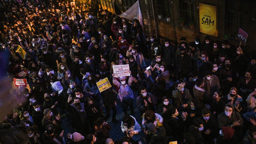 People protest in a street of Istanbul on February 2, 2021 after clashes erupt during a demonstration against Turkish President's appointment of a party loyalist to head Istanbul's exclusive Bogazici University at the start of the year. - Turkey has been hit by weeks of rallies across major campuses and the standoff over the rector gained a new dimension when protesters hung a poster near his office depicting Islam's holiest site covered in LGBT imagery last week. (Photo by Bulent Kilic / AFP) (Photo by BUL