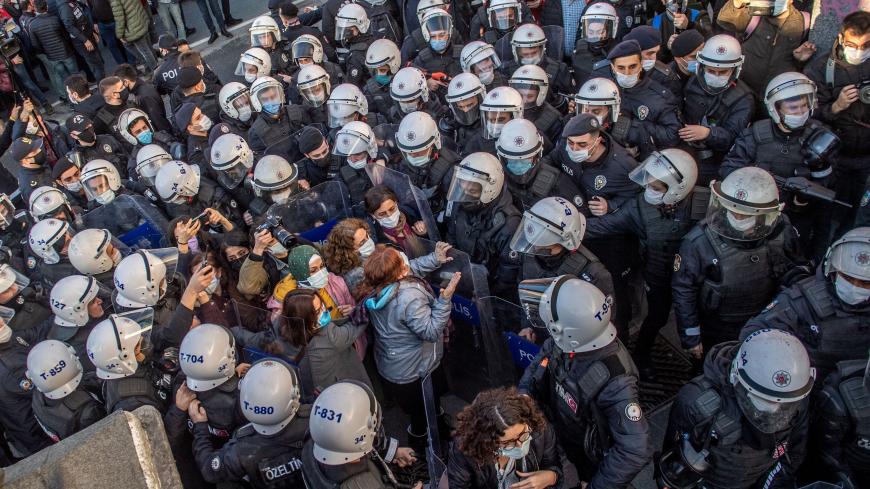 TOPSHOT - Turkish police officers detain protestors during a rally in support of Bogazici University students protesting against the appointment of Melih Bulu, a ruling Justice and Development Party (AKP) loyalist, as the new rector of the university, in Istanbul on February 4, 2021. - Students are protesting against the Turkish president's decision last month (January 1) to name party loyalist Melih Bulu to head Istanbul's elite Bogazici University, with many  students seeing his appointment as a part of t