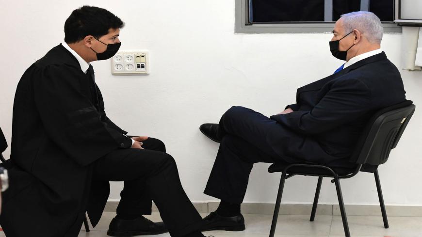 Israeli Prime Minister Benjamin Netanyahu (R) talks to his lawyer ahead of a hearing in his corruption trial at the Jerusalem district court, on February 8, 2021. - Israel's Prime Minister Benjamin Netanyahu denied corruption charges against him in a brief court appearance, as his graft trial intensifies weeks before a fourth national election inside two years. (Photo by Reuven Castro / POOL / AFP) (Photo by REUVEN CASTRO/POOL/AFP via Getty Images)