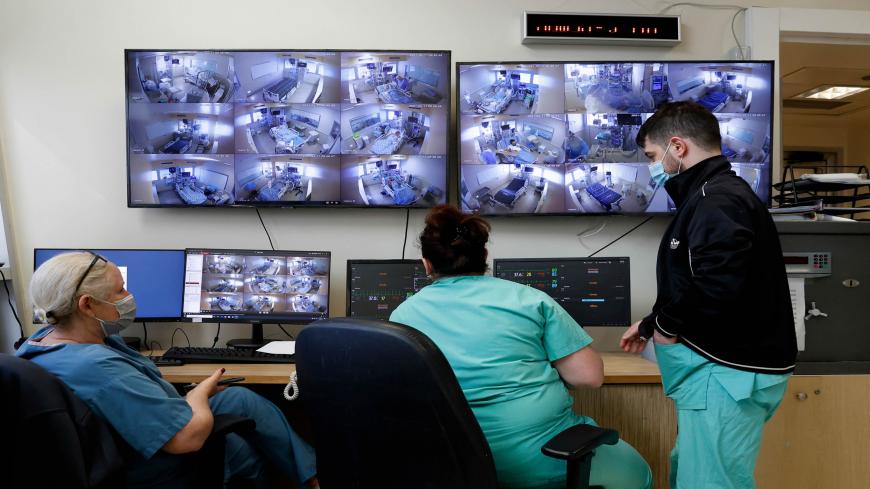 Israeli health workers monitor Covid-19 patients an isolation ward at Ichilov Medical Centre in Tel Aviv, on February 11, 2021. (Photo by JACK GUEZ / AFP) (Photo by JACK GUEZ/AFP via Getty Images)
