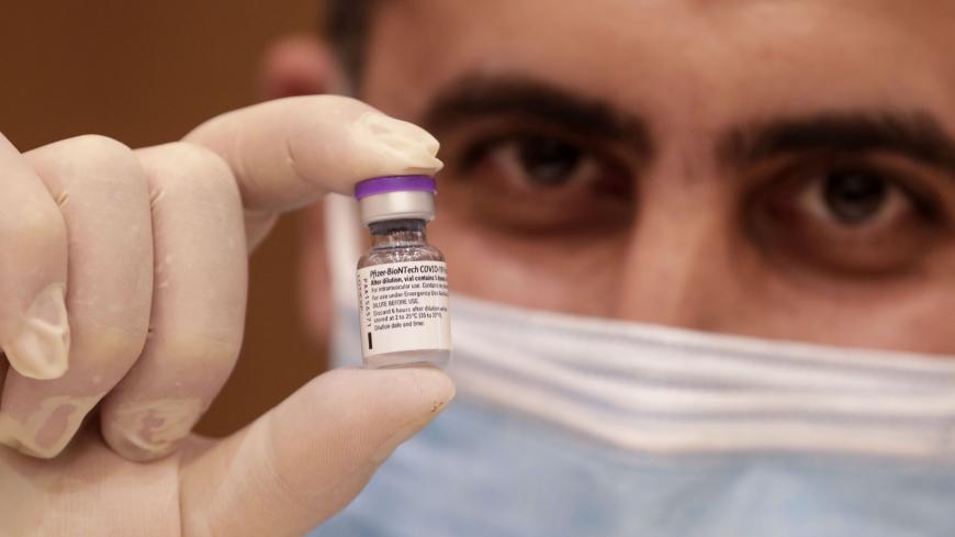A medic prepares a dose of the COVID-19 Pfizer/BioNTech vaccine at Lebanon's American University Medical Center in the capital Beirut, on February 14, 2021, as the country kickstarts its inoculation campaign. - Lebanon gave its first COVID-19 vaccine dose to a doctor, as it started inoculation it hopes will keep the pandemic in check amid a deepening economic crisis. (Photo by ANWAR AMRO / AFP) (Photo by ANWAR AMRO/AFP via Getty Images)