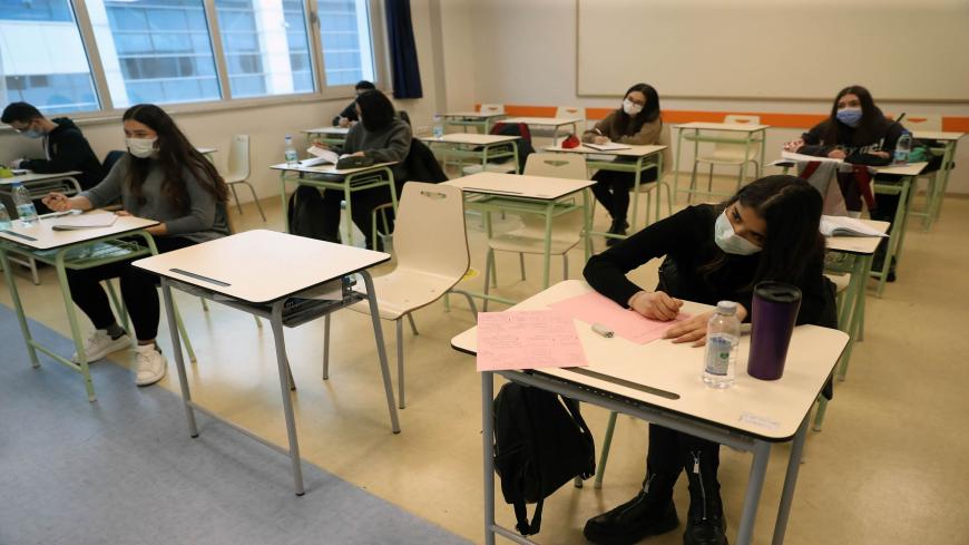 Students wearing protective face masks attend a lesson at a private school in Ankara, on February 15, 2021, amid the crisis linked with the Covid-19 pandemic. (Photo by Adem ALTAN / AFP) (Photo by ADEM ALTAN/AFP via Getty Images)