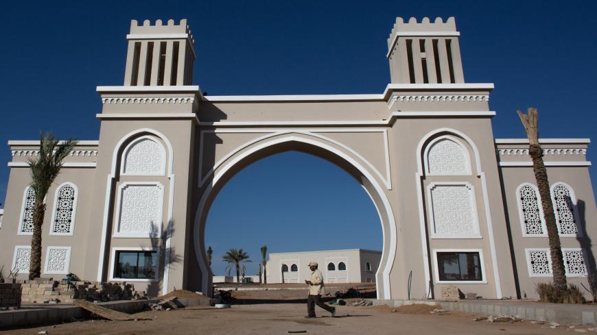 SHARM EL SHEIKH, EGYPT - APRIL 03: A man walks in front of a new hotel under construction in Nabq district on April 3, 2016 in Sharm El Sheikh, Egypt. Prior to the Arab Spring in 2011 some 15million tourists would visit Egypt each year. The resort town of Sharm El Sheikh was built around tourism however tourist numbers have plummeted after recent terrorist attacks with flights from major UK carriers being suspended and foreign offices around the world warning citizens of the 'High threat from terrorism' Sha