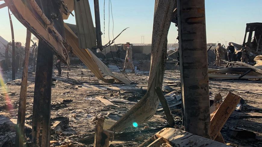 A picture taken on January 13, 2020 during a press tour organised by the US-led coalition fighting the remnants of the Islamic State group, shows US soldiers clearing rubble at Ain al-Asad military airbase in the western Iraqi province of Anbar. - Iran last week launched a wave of missiles at the sprawling Ain al-Asad airbase in western Iraq and a base in Arbil, capital of Iraq's autonomous Kurdish region, both hosting US and other foreign troops, in retaliation for the US killing top Iranian general Qasem 