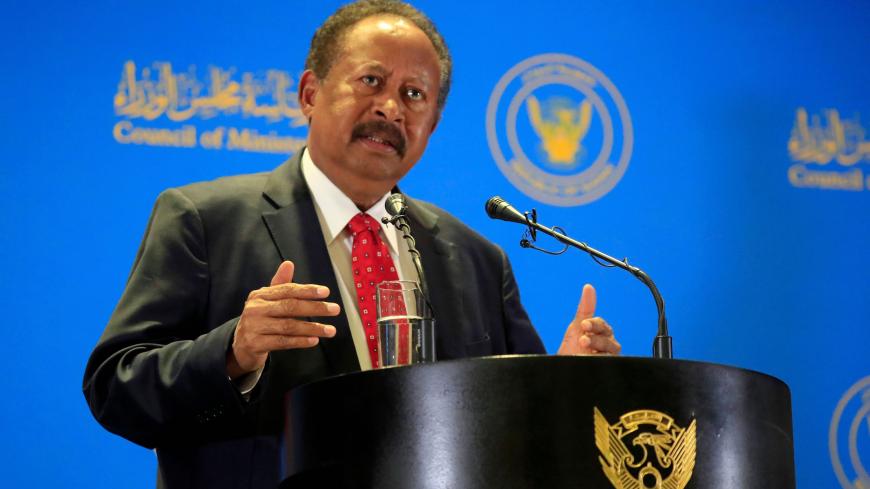 Sudanese Prime Minister Abdalla Hamdok speaks during a press conference in Khartoum on February 8, 2021. - Sudan's ruling body said today it would announce a new cabinet to include ex-rebel chiefs as ministers, following a peace deal in October aimed to end decades of war. Hamdok dissolved the cabinet the previous day to make way for a more inclusive lineup, with the new government expected to bring in seven ministers from former rebel groups. (Photo by ASHRAF SHAZLY / AFP) (Photo by ASHRAF SHAZLY/AFP via G