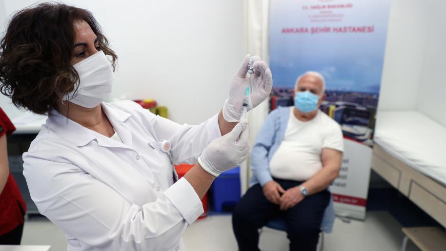 A man waits to receive the COVID-19 vaccine the at Ankara City Hospital in Ankara on March 1,  2021. - The country started mass COVID-19 vaccination on January 14, after the authorities approved the emergency use of the Chinese CoronaVac vaccine. More than 8,857,445 people have been vaccinated so far. (Photo by Adem ALTAN / AFP) (Photo by ADEM ALTAN/AFP via Getty Images)