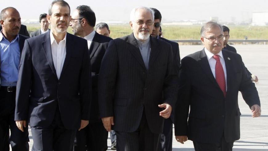 Iran's Foreign Minister Mohammad Javad Zarif (C) arrives at Baghdad International Airport September 8, 2013. Zarif visited Iraq on Sunday to discuss what he called the "dangerous situation" in Syria and the wider region. REUTERS/ Saad Shalash (IRAQ - Tags: POLITICS) - RTX13CKO