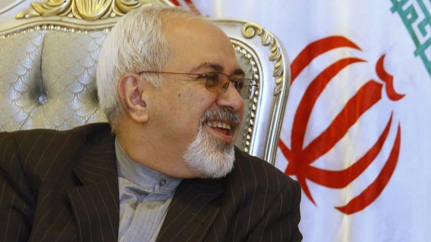 Iran's Foreign Minister Mohammad Javad Zarif smiles during a meeting with his Iraqi counterpart Hoshyar Zebari (not in picture) at the Baghdad International Airport September 8, 2013. Zarif visited Iraq on Sunday to discuss what he called the "dangerous situation" in Syria and the wider region. REUTERS/ Saad Shalash (IRAQ - Tags: POLITICS) - RTX13CKS