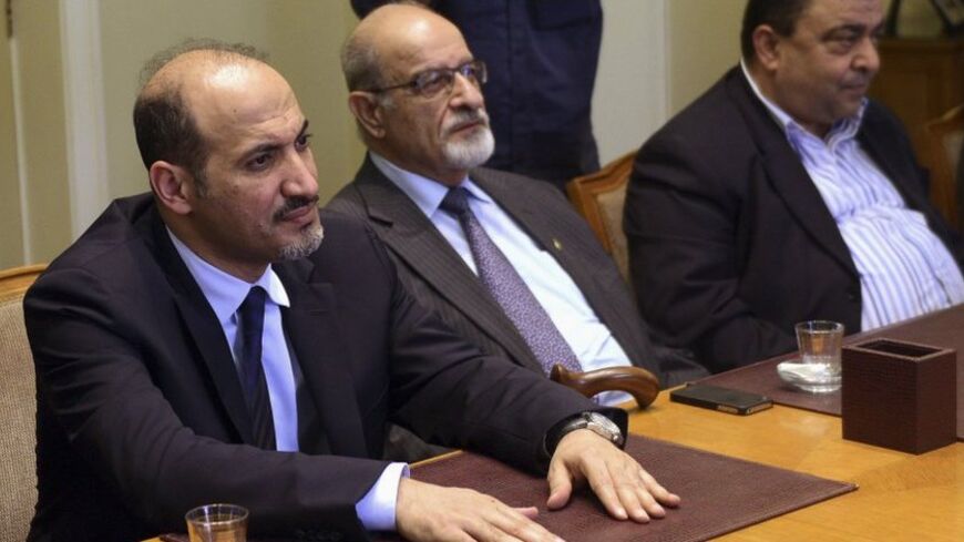 President of the Syrian National Coalition, Ahmad Al-Jarba (L), looks on during a meeting with Arab League Secretary General Nabil al-Arabi (not pictured) in Cairo, November 2, 2013. Arab League Foreign Ministers will meet in Cairo in an emergency session to discuss the ongoing crisis in Syria on Sunday. REUTERS/Stringer (EGYPT - Tags: POLITICS) - RTX14XDS