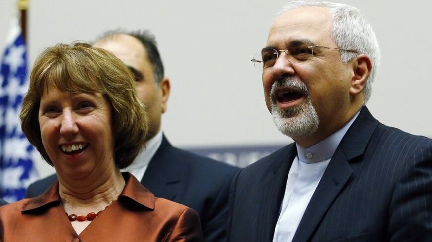 European Union foreign policy chief Catherine Ashton (L) smiles next to Iranian Foreign Minister Mohammad Javad Zarif during a ceremony at the United Nations in Geneva November 24, 2013. Iran and six world powers reached a breakthrough agreement early on Sunday to curb Tehran's nuclear programme in exchange for limited sanctions relief, in a first step towards resolving a dangerous decade-old standoff. REUTERS/Denis Balibouse (SWITZERLAND - Tags: POLITICS ENERGY TPX IMAGES OF THE DAY) - RTX15QNS