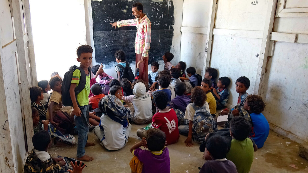 Displaced Yemeni boys attend a class at a makeshift school run by volunteers, in the war-ravaged western province of Hodeida, on March 14, 2021.