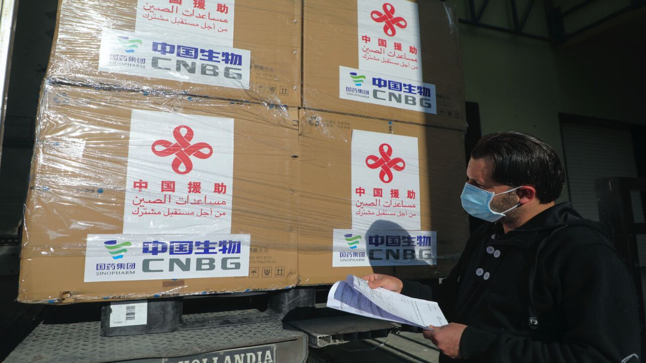 A Palestinian worker unloads a shipment of the Sinopharm COVID-19 vaccines donated by the Chinese government in the West Bank city of Nablus, on March 29, 2021.