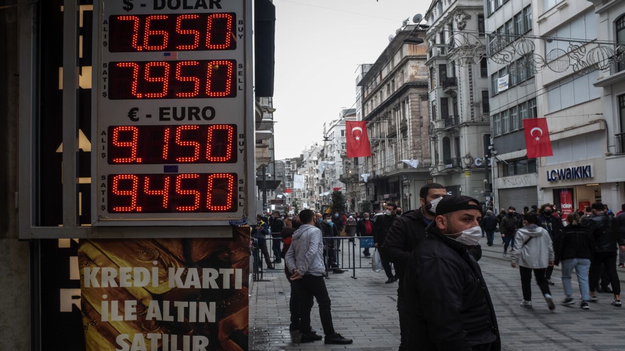 People walk past a currency exchange board on March 22, 2021, in Istanbul, Turkey. Turkey's lira plummeted as much as 15% to hit 8.39 per US dollar in the first day of trading after Turkey's President Recep Tayyip Erdogan replaced central bank governor Naci Agbal, triggering fears of another currency crisis.