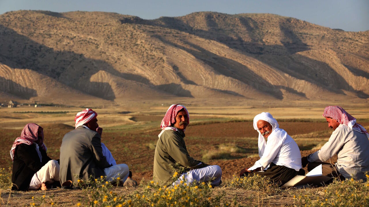 Displaced Iraqis from the Yazidi community, who fled violence between Islamic State (IS) group jihadists and Peshmerga fighters in the northern Iraqi town of Sinjar, sit in a field near a camp for internally displaced persons (IDP) in the Sharya area some 15 kilometres from the northern Iraqi city of Dohuk on May 20, 2015.