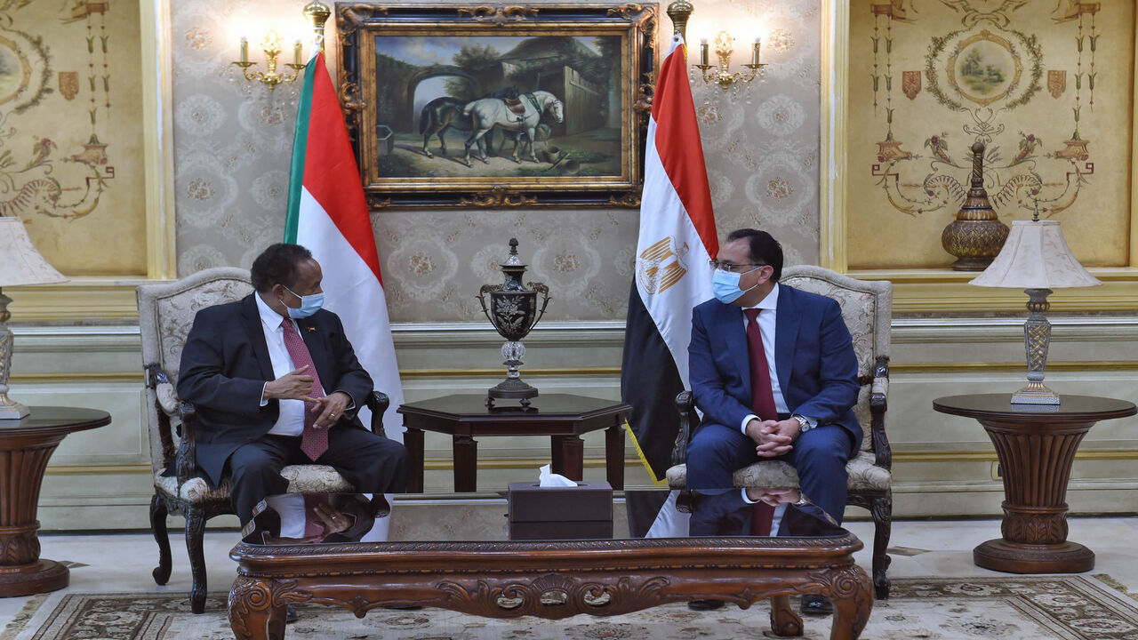 Egyptian Prime Minister Mostafa Madbouly (R) and his Sudanese counterpart Abdalla Hamdok meet in Cairo, Egypt, March 11, 2021.