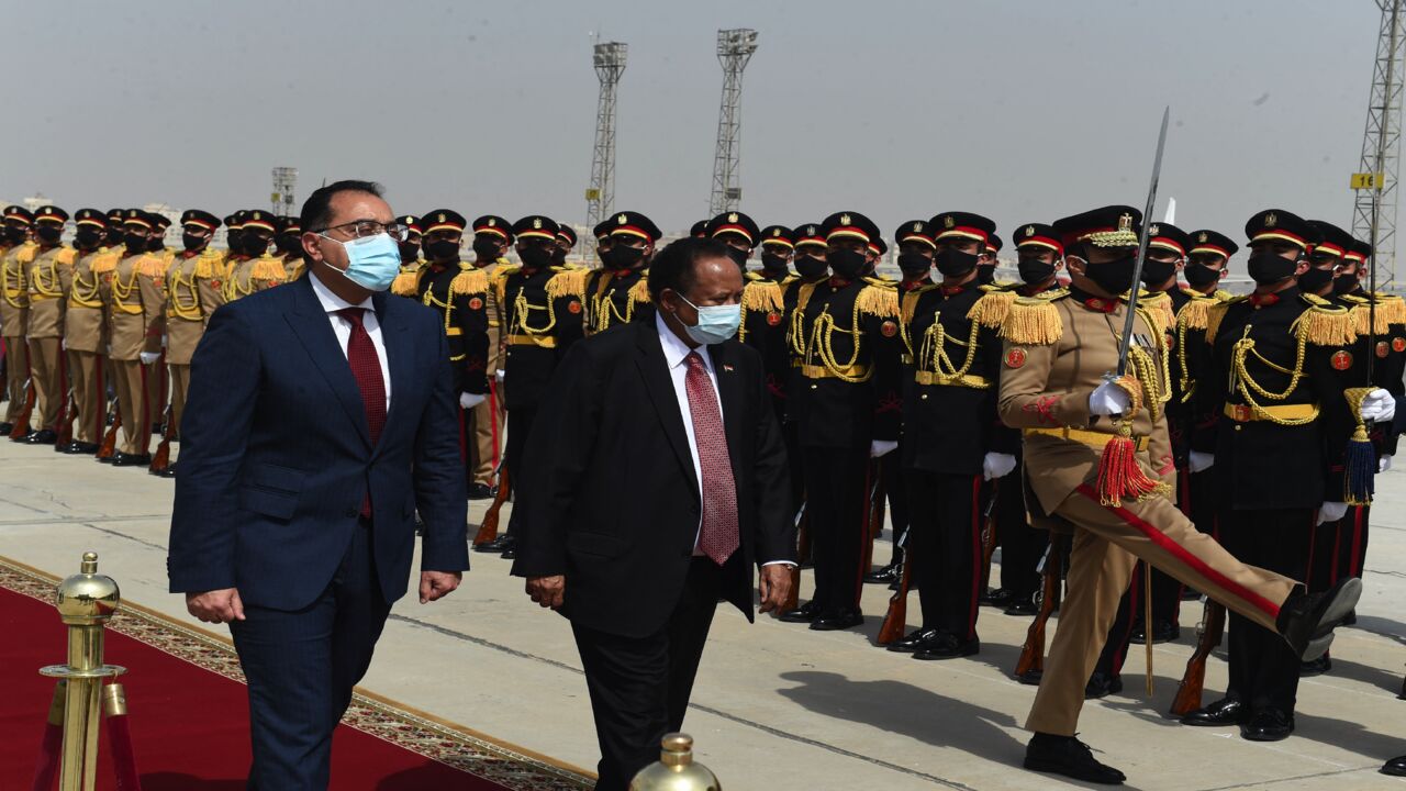 Egyptian Prime Minister Mostafa Madbouly (L) welcomes his Sudanese counterpart, Abdalla Hamdok, upon his arrival in the Egyptian capital, Cairo, on March 11, 2021. Sudan, Egypt and Ethiopia have been locked for almost a decade in inconclusive talks over the filling and operation of the Grand Ethiopian Renaissance Dam (GERD) on the Blue Nile, which broke ground in 2011.