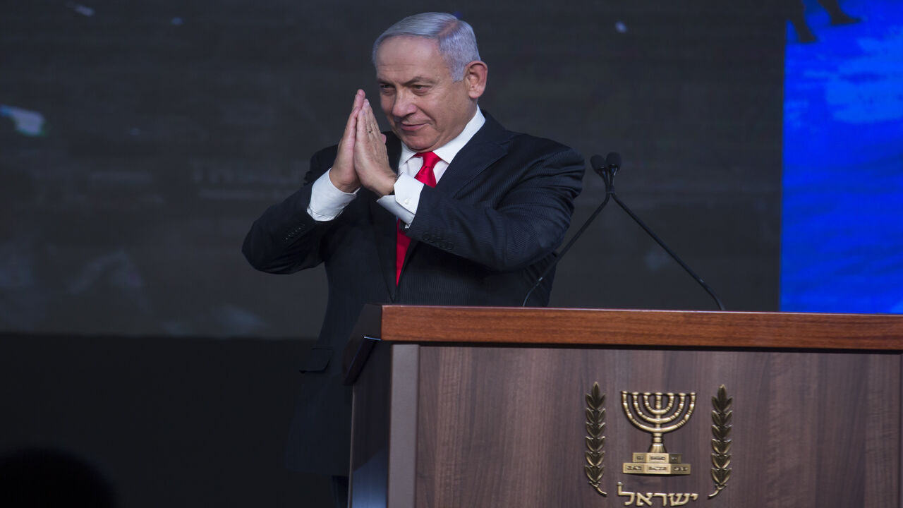 Israeli Prime Minster Benjamin Netanyahu greets supporters as he speaks at a Likud party gathering after a vote event, Jerusalem, March 24, 2021.