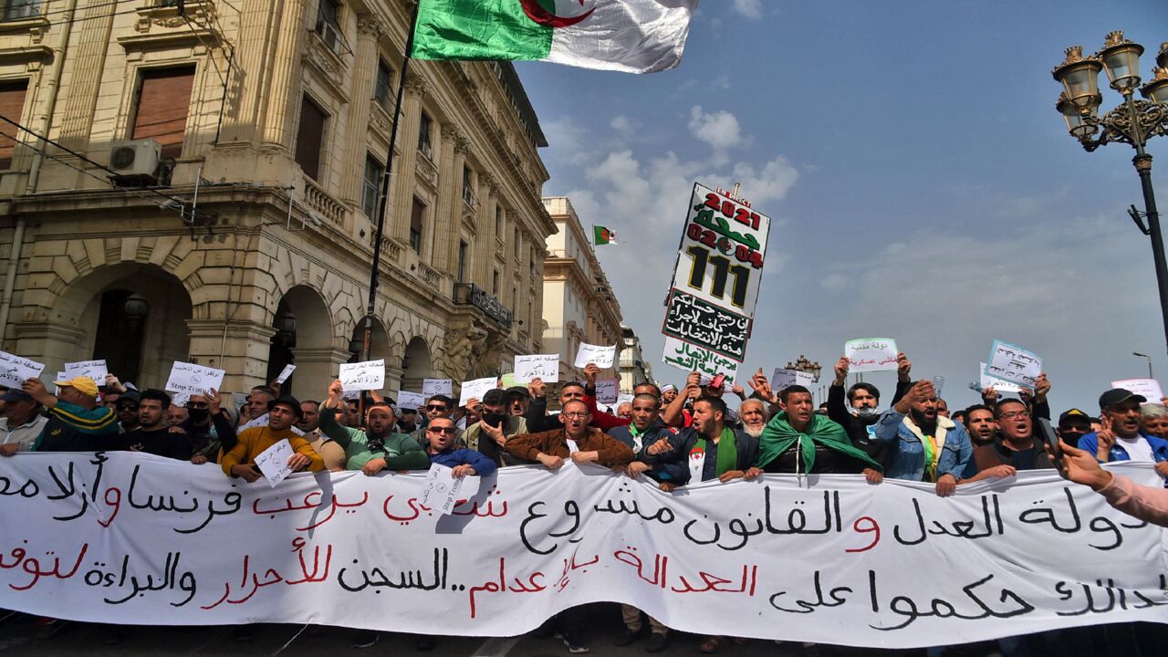 Algerians carry a large banner during an anti-government demonstration in the capital, Algiers, on April 2, 2021.