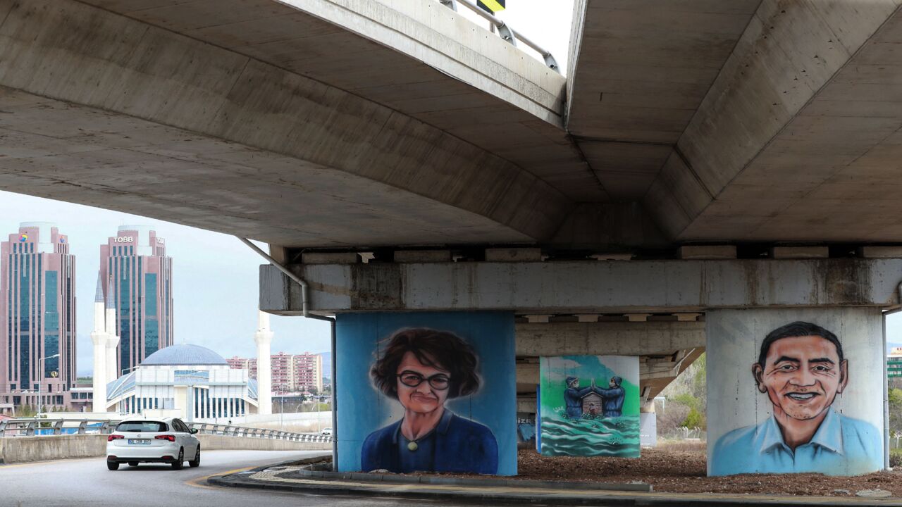 Ankara's Metropolitan Municipality paid tribute to Ozlem Tureci (L) and Ugur Sahin (R), the German couple of Turkish origin who are behind the BioNTech firm that developed a successful vaccine with US giant Pfizer, as part of a series of graffiti dedicated to the efforts of health care workers during the COVID-19 pandemic in the City Hospital region of the Turkish capital, Ankara, on April 19, 2021. 