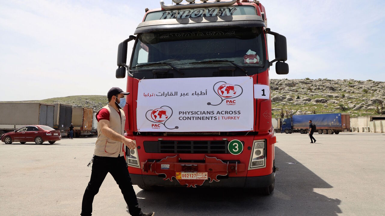A truck carrying the first batch of AstraZeneca COVID-19 vaccines arrives at Bab al-Hawa border crossing between Syria and Turkey in Syria's rebel-held northwestern Idlib on April 21, 2021.