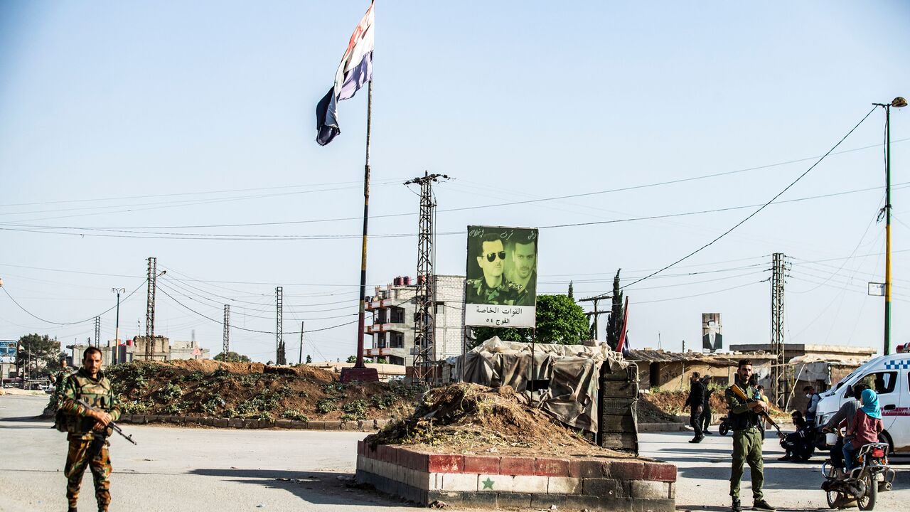 Members of the Syrian Kurdish internal security services known as Asayish and Syrian government forces man a checkpoint in Tayy neighbourhood in the northeastern city of Qamishli, after the implementation of a Russian-brokered cease-fire agreement, Syria, April 27, 2021.