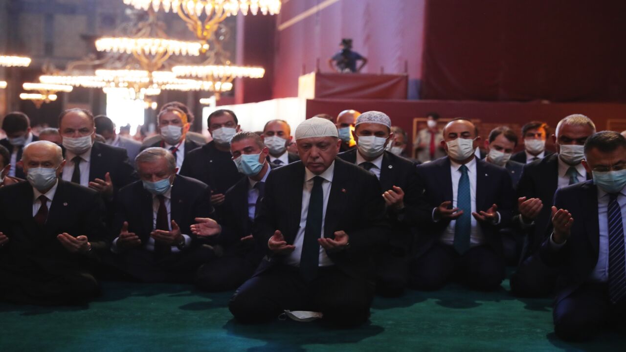 In this handout picture released by the Turkish presidential press office, Turkey's President Recep Tayyip Erdogan (C) and invited guests attend Friday prayers at Hagia Sophia Grand Mosque during the building's first official prayers after being reconverted into a mosque on July 24, 2020, in Istanbul, Turkey.