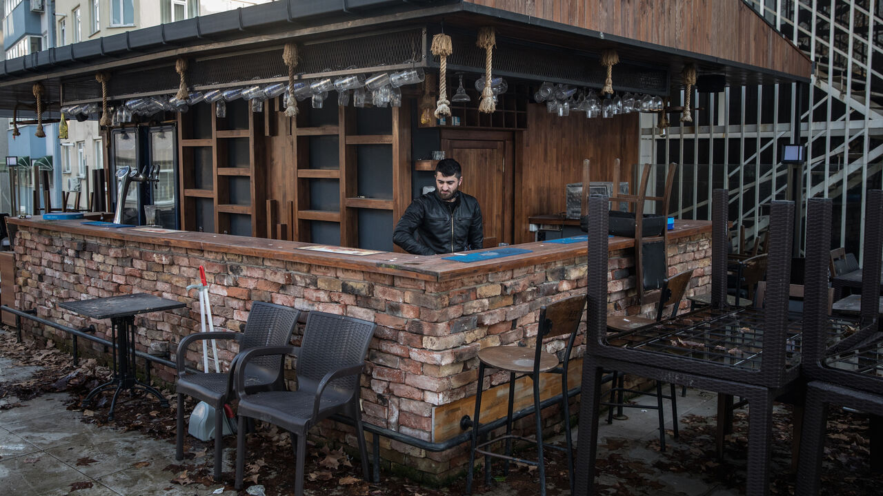 An employee of Dilo bar starts cleaning the rooftop terrace bar, which has been closed for 340 days due to coronavirus restrictions, in the Kadikoy district on Feb. 22, 2021 in Istanbul, Turkey. 