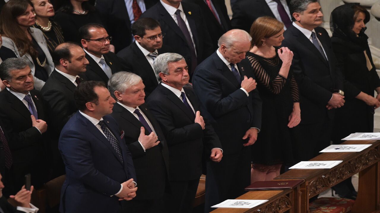 Armenia's President Serzh Sargsyan (3rd L) and US Vice President Joe Biden (C) cross themselves during a prayer service commemorating the 100th anniversary of the Armenian Genocide at the National Cathedral on May 7, 2015, in Washington, DC. 