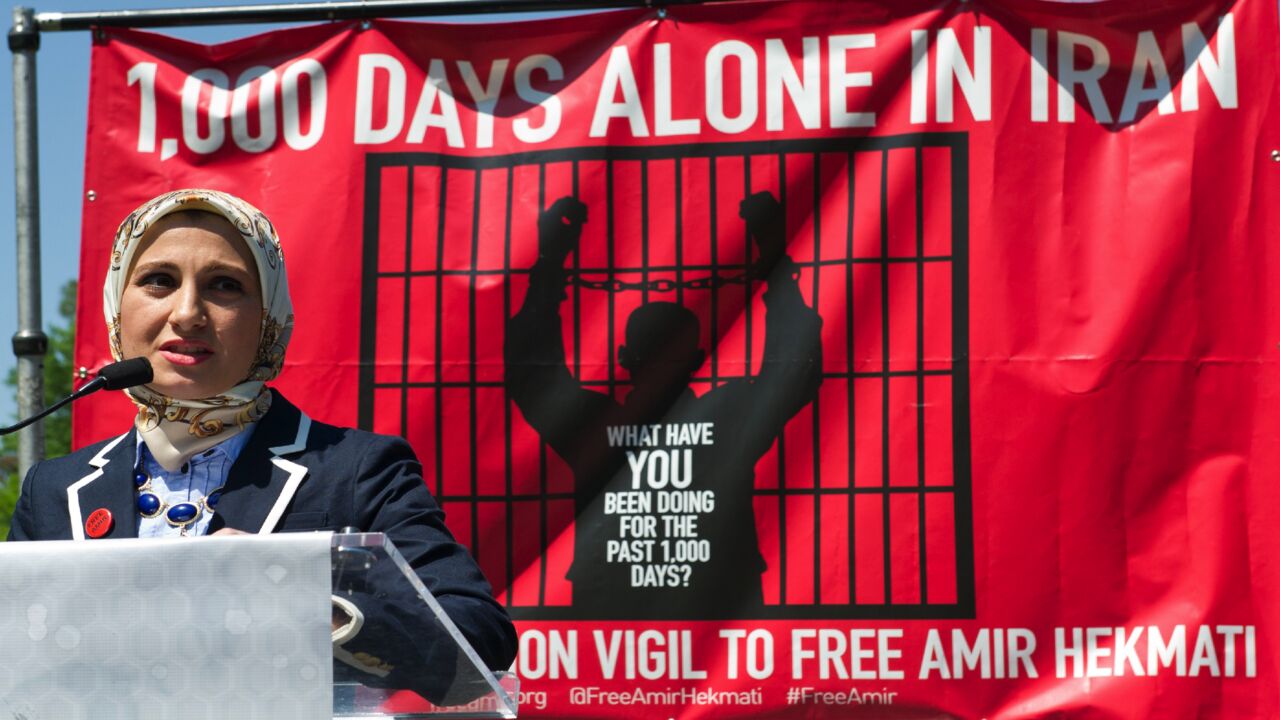 Sarah Hekmati (R), sister of US Marine Corps veteran Amir Hekmati, speaks about her brother on May 19, 2014, during a vigil held for him in Lafayette Park across from the White House in Washington, DC. The vigil was held on the 1,000th day of Amir's imprisonment in Iran. Amir is an Iranian-American detained in Iran while visiting his grandmother. Falsely accused of being a spy, he was detained in August of 2011, held in solitary confinement for months and hidden by the walls of Irans Evin prison. He was sen