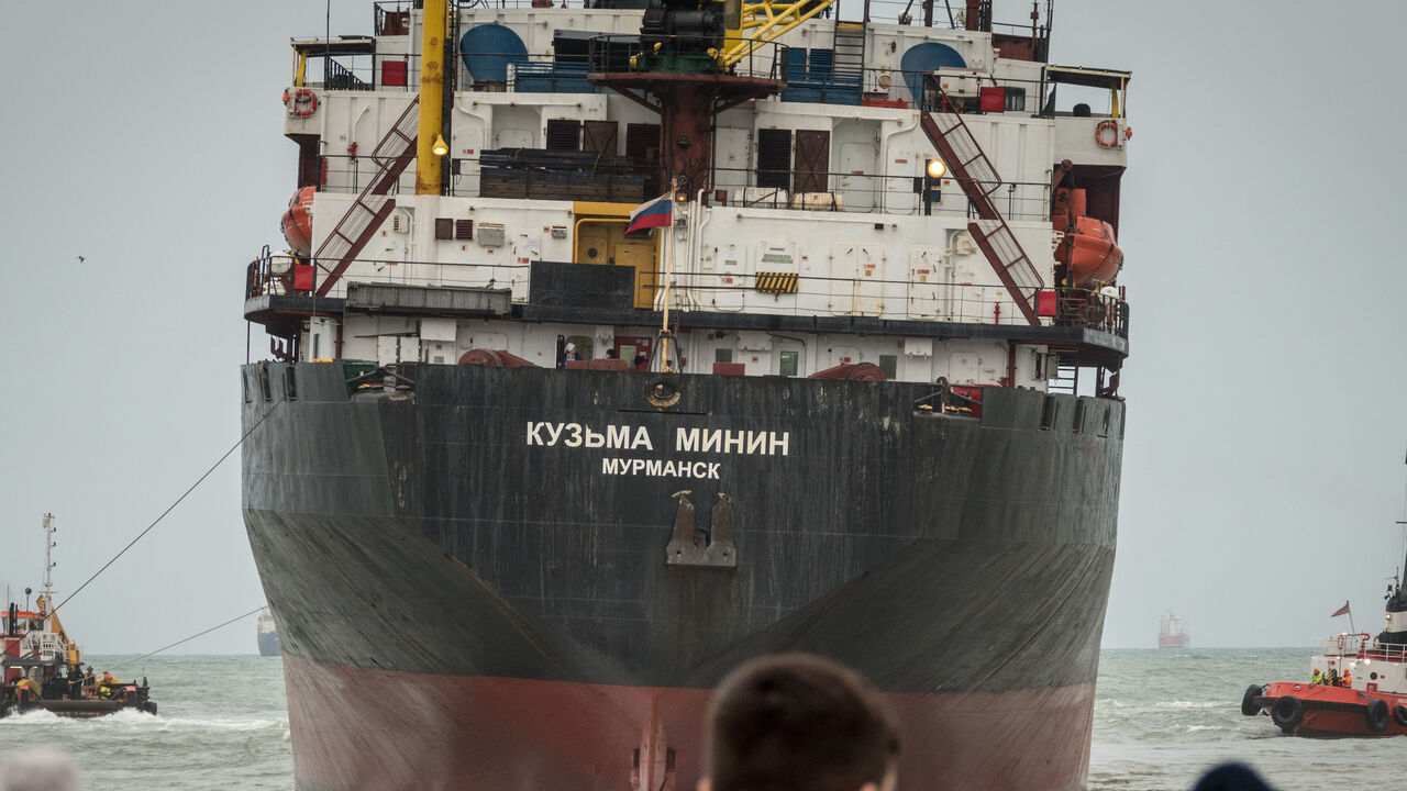 Locals watch as the the stricken Kuzma Minin is towed out to sea in Falmouth on Dec. 18, 2018 in Cornwall, England.