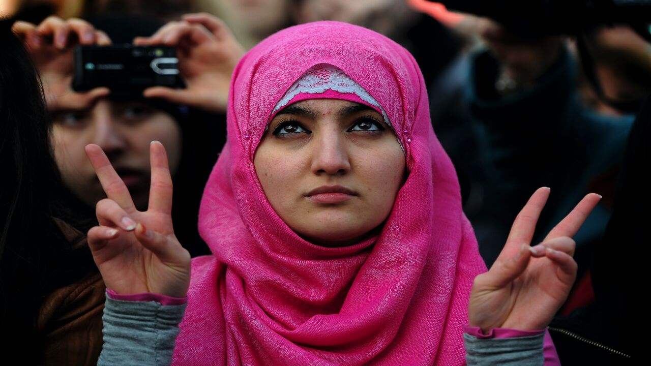 A protestor makes the "victory sign" with her hands during a global solidarity demonstration for political change in Egypt in Trafalgar Square, London, on Feb. 12, 2011. The event was organized by Amnesty International and the ITUC, Human Rights Watch, the NUS, the Cairo Institute for Human Rights Studies, the Egyptian Initiative for Personal Rights, the Euro-Mediterranean Human Rights Network and the Arab Program for Human Rights Activists.