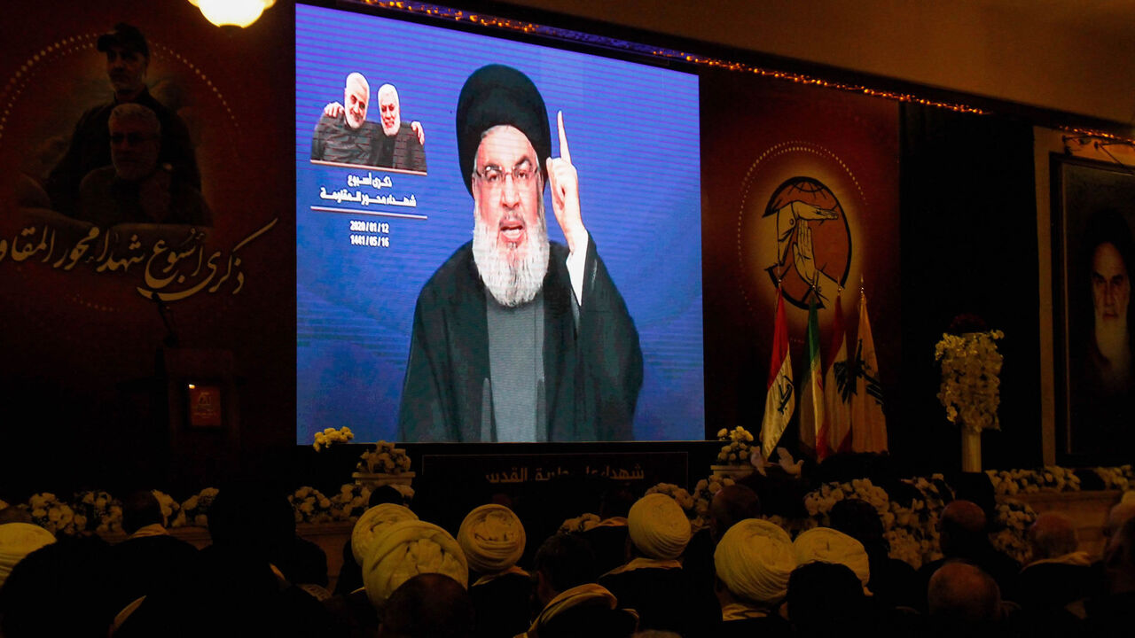 Supporters of the Shiite Hezbollah movement watch as the movement's leader Hassan Nasrallah delivers a speech on a screen in the southern city of Nabatieh, Lebanon, Jan. 12, 2020.