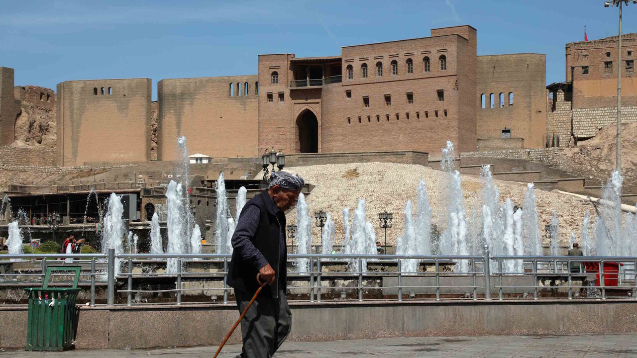 An Iraqi Kurdish man walks past a fountain in front of Arbil's Citadel in the capital of the autonomous Kurdish region in northern Iraq, on April 15, 2021.