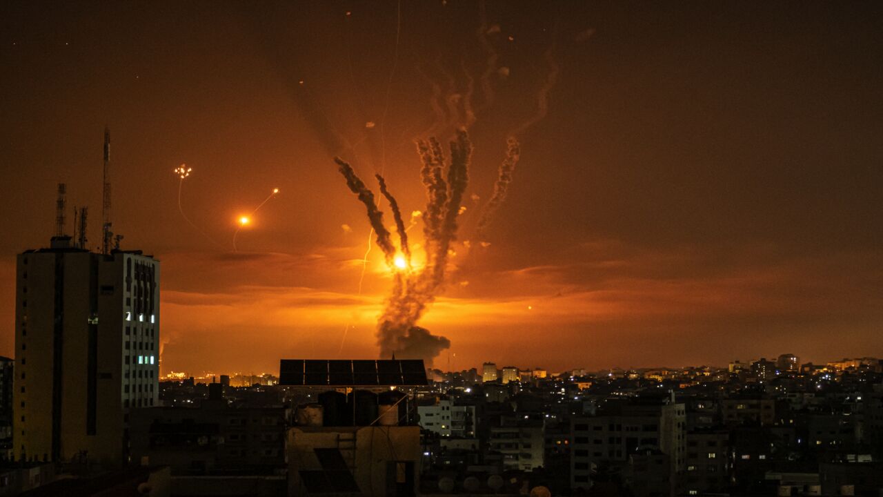 Rockets launched toward Israel from the northern Gaza Strip and response from the Israeli missile defense system known as the Iron Dome leave streaks through the sky on May 14, 2021, in Gaza City, Gaza.