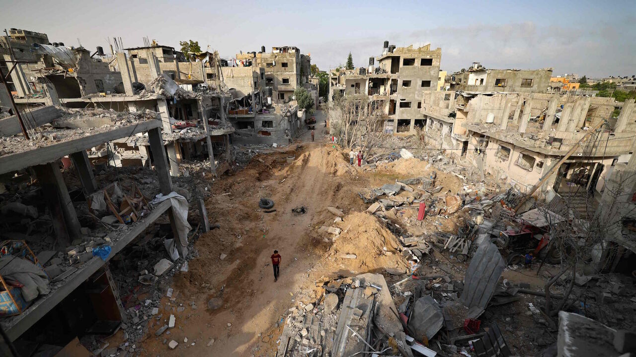 A Palestinian man walks in a neighborhood hit by Israeli bombardment in Gaza City, after a ceasefire brokered by Egypt between Israel and Hamas, on May 21, 2021.