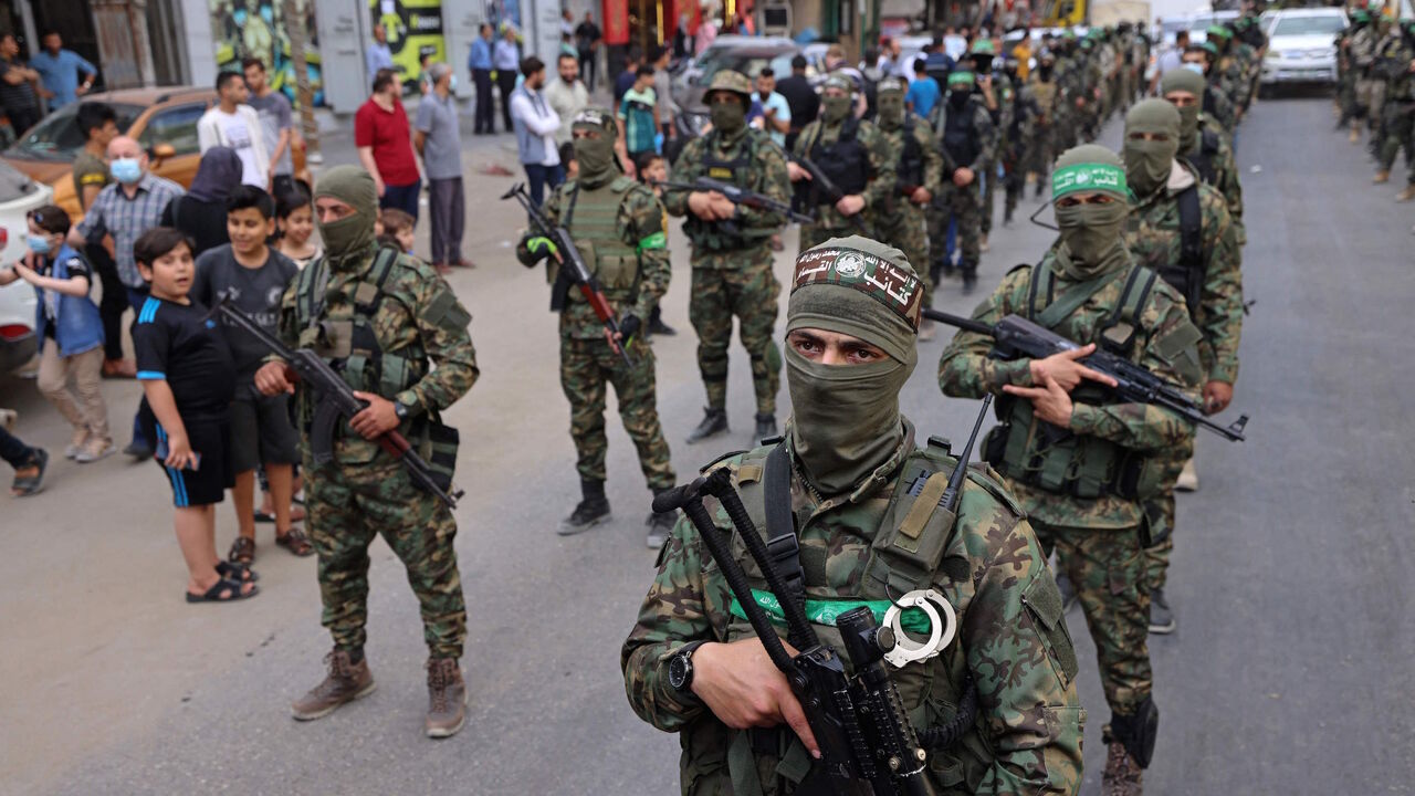 Members of Al-Qassam Brigades, the armed wing of the Palestinian Hamas movement, march in Gaza City on May 22, 2021, in commemoration of senior Hamas commander Bassem Issa who was killed along with other militants in Israeli airstrikes last week.