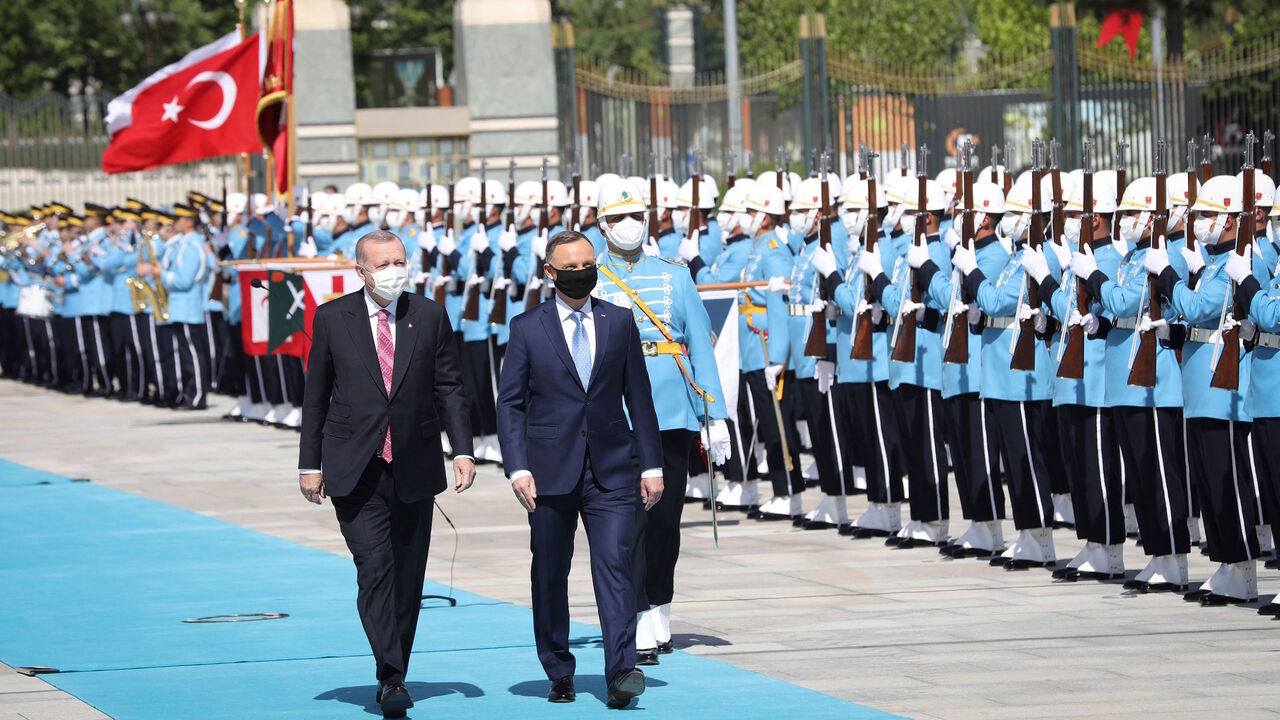 Turkish President Recep Tayyip Erdogan (L) welcomes Poland's President Andrzej Duda (R) ahead of their meeting at the Presidential Complex in Ankara, on May 24, 2021.