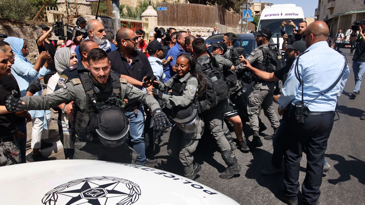 Palestinians scuffle with Israeli security forces outside the court in Jerusalem on May 26, 2021 during a protest over Israel's planned evictions of Palestinian families from homes in the eastern sector's Silwan district.