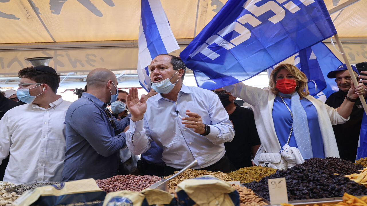 Israeli parliament member and former Jerusalem Mayor Nir Barkat meets voters during the election campaign for the Likud party, at Mahane Yehuda market, Jerusalem, March 19, 2021.