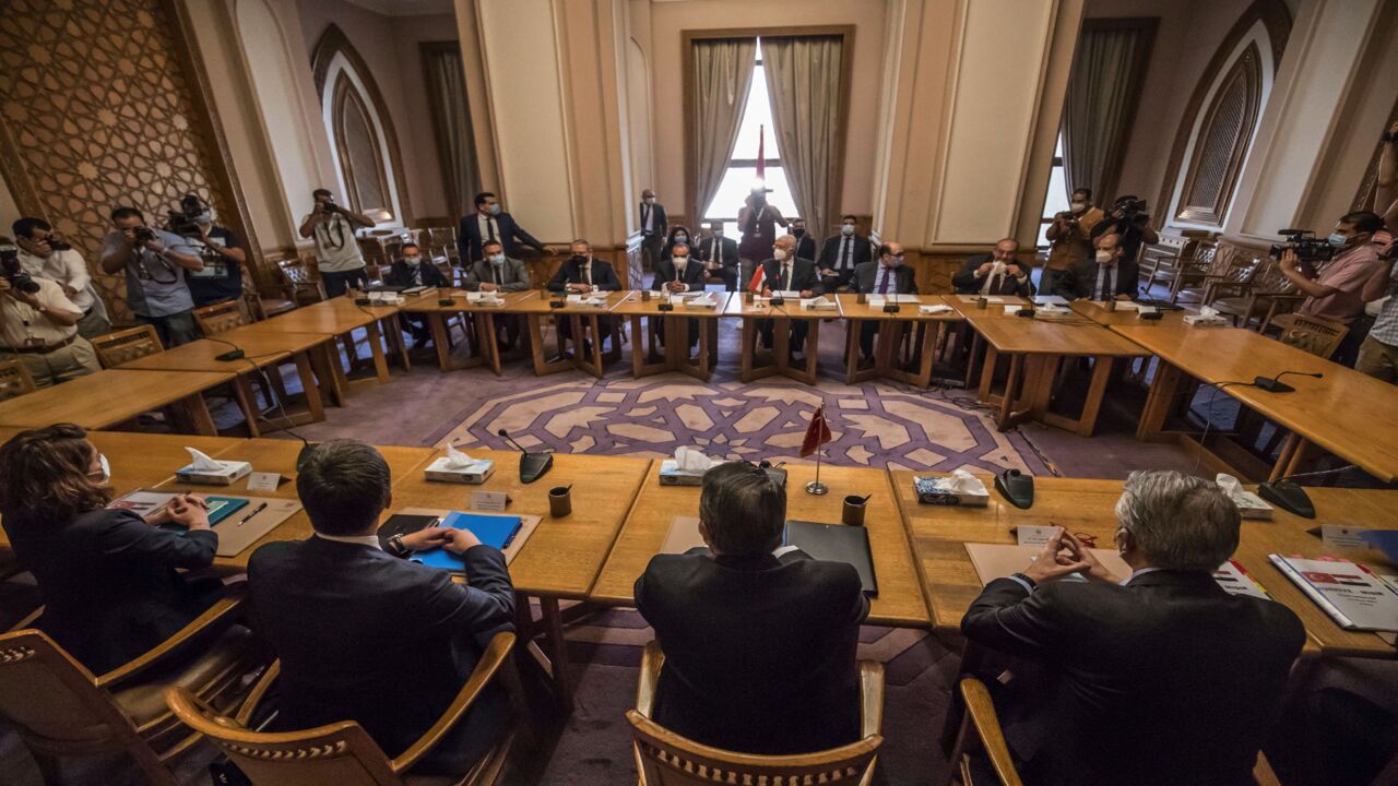 Egypt's Deputy Foreign Minister Hamdi Sanad Loza (background) meets with his Turkish counterpart Sedat Onal (foreground) in the Foreign Ministry headquarters in the Egyptian capital, Cairo, on May 5, 2021. 